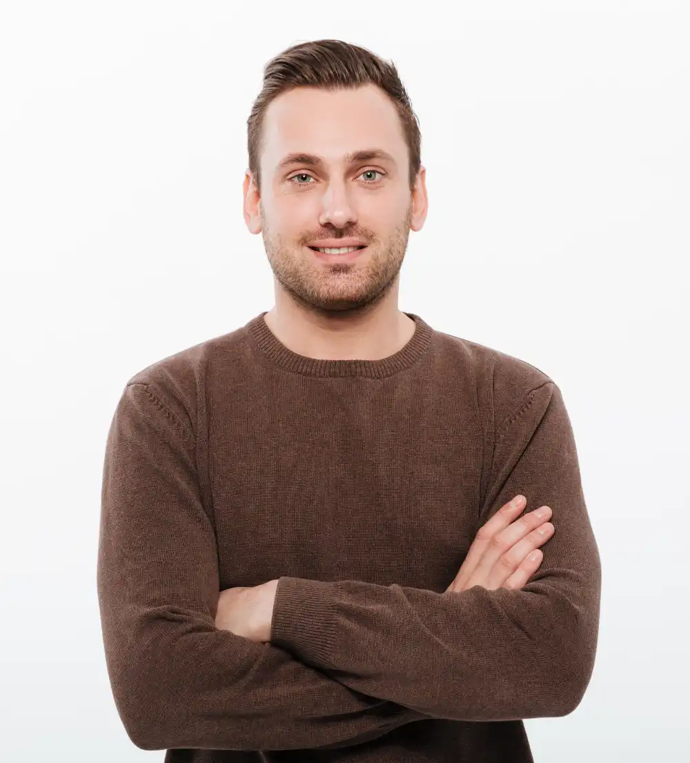 handsome young cheerful man with arms crossed