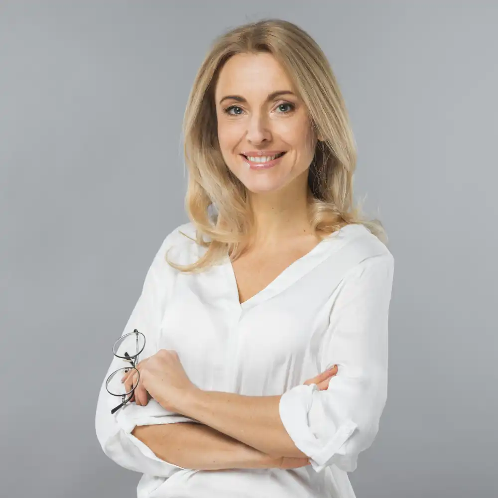portrait young businesswoman holding eyeglasses hand against gray backdrop